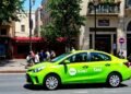 Vibrant lime green taxi parked on city street with pedestrians