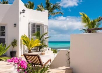 Sunny beach patio with palm trees and ocean view