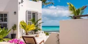 Sunny beach patio with palm trees and ocean view